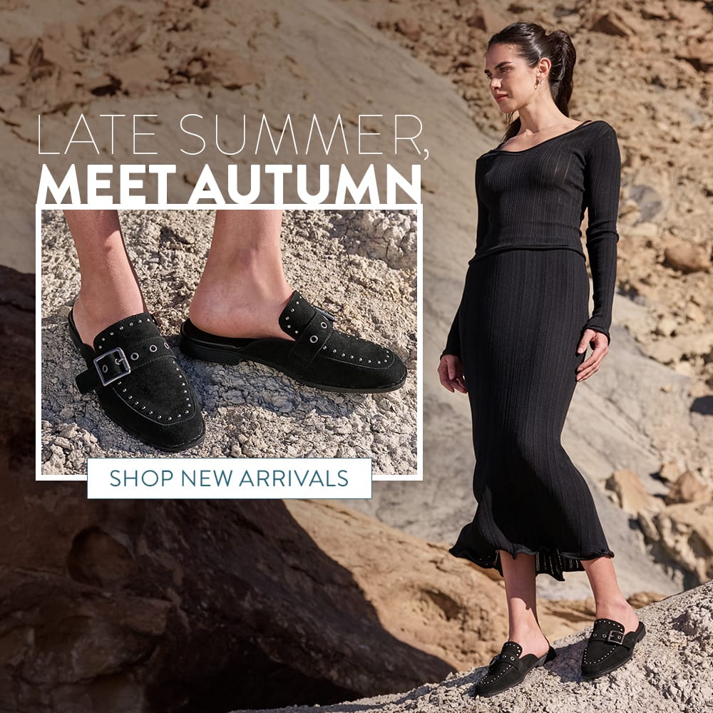 Late Summer, Meet Autumn. Shop New Arrivals. A woman standing in the desert wearing the Mikah Stud open back clogs in black suede.
