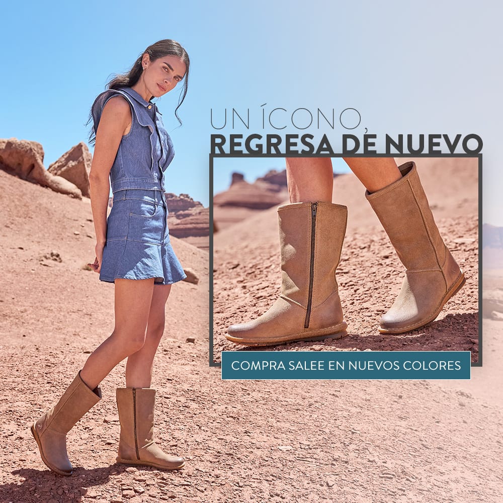 Un &Iacute;cono, Regresa de Nuevo. Compra Salee en Nuevos Colores. Una mujer parada en el desierto usando las botas altas con cierre lateral Salee en gamuza canela.