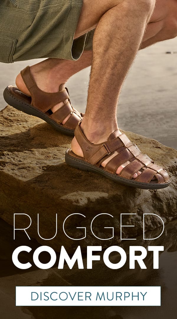 Rugged Comfort. Discover Murphy. A man crouched on a rock by the ocean wearing the Murphy closed-toe sandals in brown.
