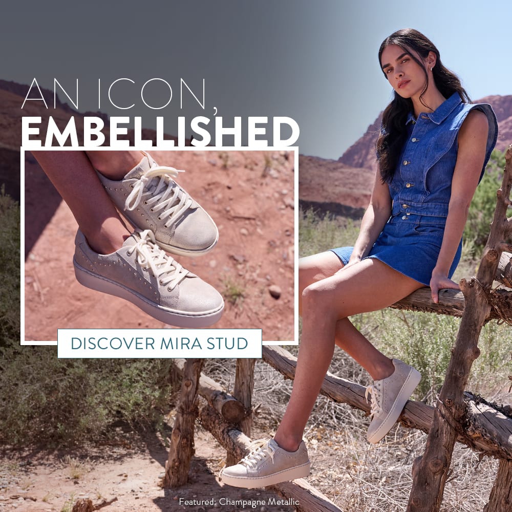 An Icon, Embellished. A woman in the desert leaning on a fence wearing the Featured: Mira Stud lace-up sneakers in metallic. Discover Mira Stud.