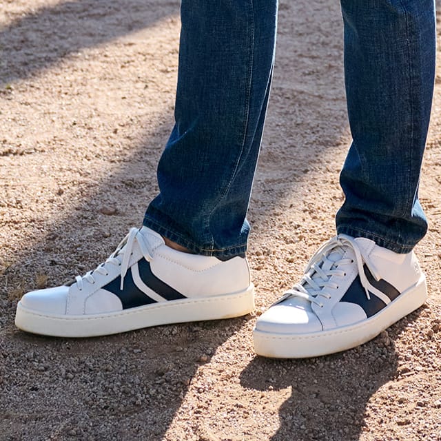 Beck lace-up sneakers in white with black stripes.